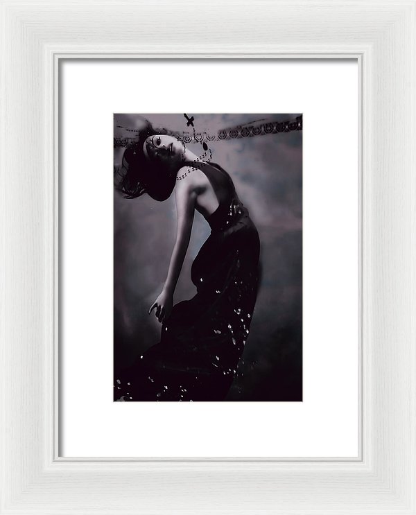 Portrait of  a woman sinking underwater with a crucifix; seeking redemption in black and white.